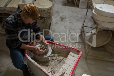 Male potter making a pot