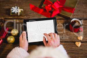 Santa Claus using digital tablet