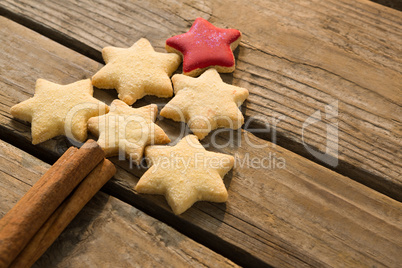 High angle view of Christmas tree made with star shape cookies and cinnamon sticks