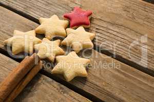High angle view of Christmas tree made with star shape cookies and cinnamon sticks