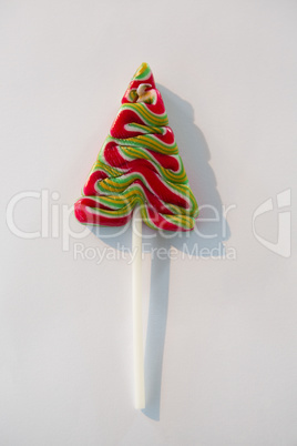 Christmas tree lollipop on white background