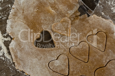 Raw cookie dough with heart shaped cookie cutter