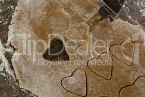 Raw cookie dough with heart shaped cookie cutter