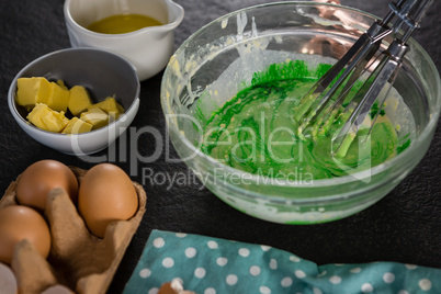 Green color batter whisked in a bowl