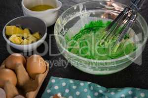 Green color batter whisked in a bowl
