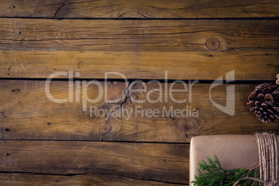 Gift box, fir and pine cone on wooden table