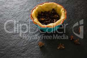 Raisin being stuffed while preparing tart