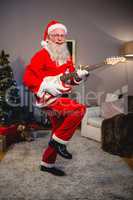 Smiling santa claus playing a guitar