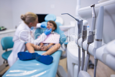 Close up of medical equipment by dentist examining boy