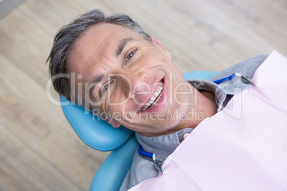 Overhead portrait of smiling man sitting on chair