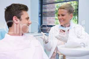 Happy patient discussing with dentist
