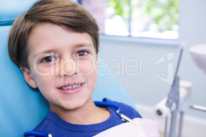 Portrait of cute boy sitting on chair