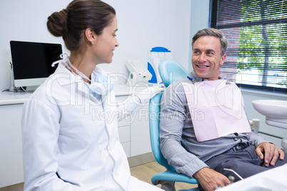 Doctor talking with patient while sitting at medical clinic