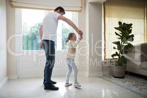 Father and daughter having fun in living room