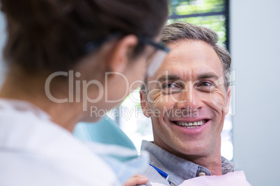 Close up of happy patient looking at dentist