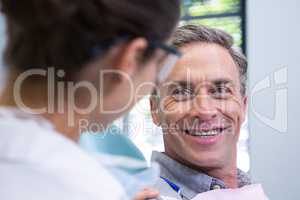 Close up of happy patient looking at dentist