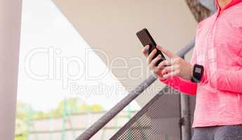Woman using mobile phone in staircase