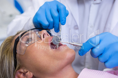 Doctor examining woman at dental clinic