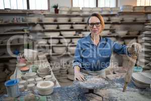 Female potter standing at worktop