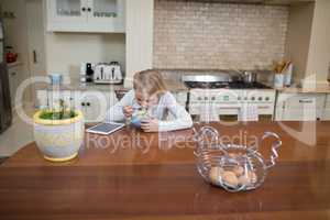 Young girl having breakfast in the kitchen
