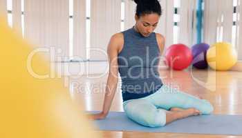 Woman performing yoga in gym