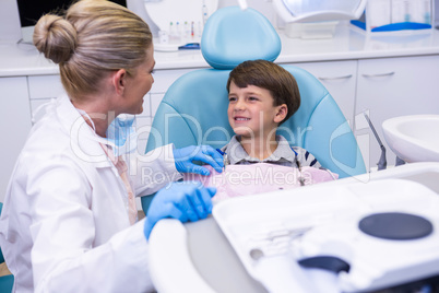 Side view of dentist talking with boy