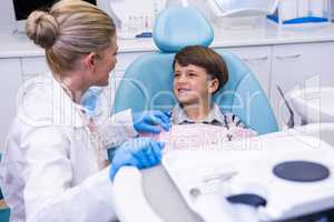 Side view of dentist talking with boy