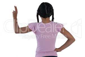 Girl pretending to touch an invisible screen against white background