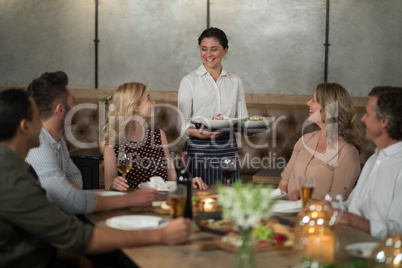 Waitress serving food to customers