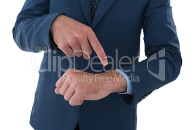 Mid section of businessman pointing on invisible wrist watch