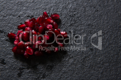 Pomegranate seeds on black background