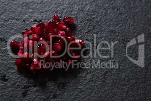 Pomegranate seeds on black background