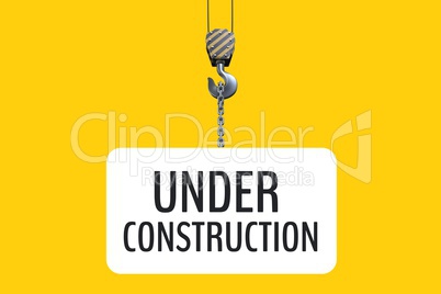 Under construction text hanging of a hook against yellow background