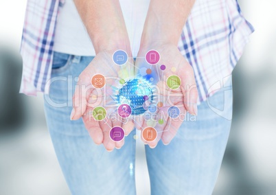 hands with application icons and world with flares