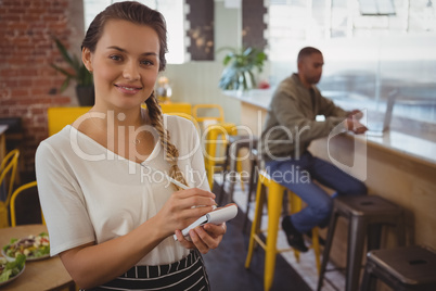 Portrait of waitress taking order by businessman