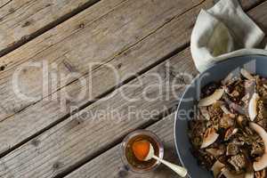 Healthy breakfast in bowl and honey on a wooden table