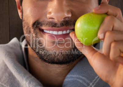 Man against wood with apple and scarf