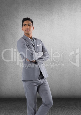 Businessman standing proudly in grey room
