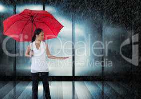 Businesswoman with umbrella by window lightning