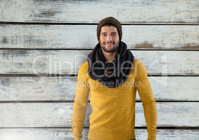 Man against wood with warm scarf and hat