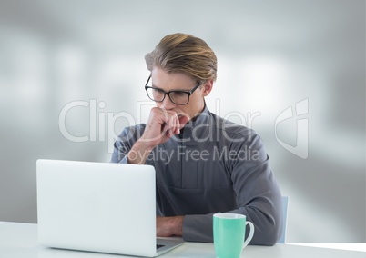 Businessman at desk with laptop with bright background