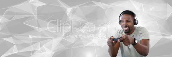 man playing with computer game controller with bright polygon background