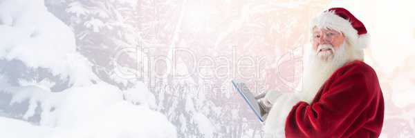 Santa Claus in Winter with tablet