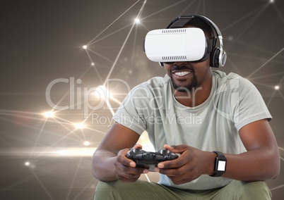 man playing with computer game controller and virtual reality headset