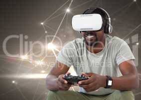 man playing with computer game controller and virtual reality headset