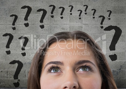 woman looking up at question marks