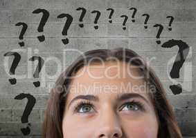 woman looking up at question marks