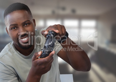 man playing with computer game controller with office background