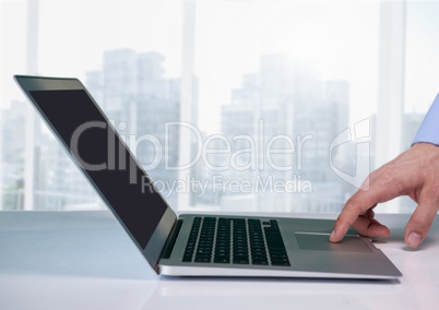 Businessman at desk with laptop with bright background