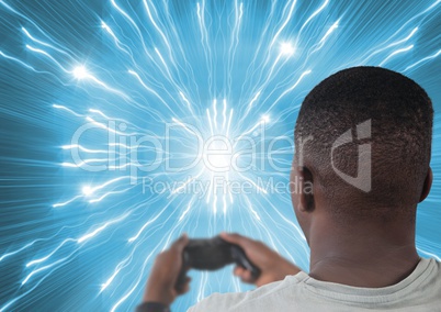 man playing with computer game controller with bright lights tunnel background